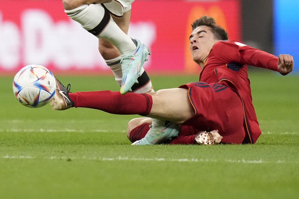 Germany's Leon Gorentzka steps on the right shin of Spain's Gavi during the World Cup group E soccer match between Spain and Germany, at the Al Bayt Stadium in Al Khor , Qatar, Sunday, Nov. 27, 2022. (AP Photo/Matthias Schrader)