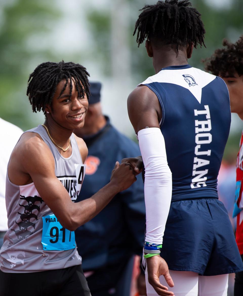 South Western's Bernard Bell (left) and Chambersburg's Jermere Jones greet each other after winning gold and silver, respectively, in the 3A 110-meter hurdles at the PIAA District 3 Track and Field Championships at Shippensburg University Saturday, May 20, 2023.