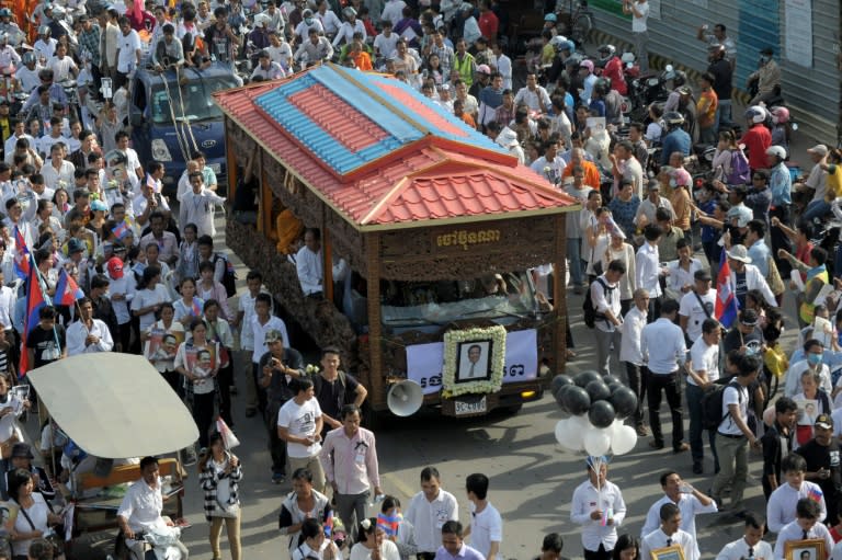 Thousands of people take part in a funeral procession in Phnom Penh on July 24, 2016, for Kem Ley, a Cambodian political analyst and pro-democracy campaigner who was shot dead in broad daylight at a convenience store two weeks earlier