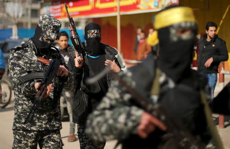 Palestinian militants take part in the funeral of their comrade Mussa Zeater, who was killed in an attack by an Israeli aircraft, in the northern Gaza Strip January 13, 2016. REUTERS/Mohammed Salem