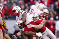 Wisconsin linebacker Leo Chenal (5) tackles Nebraska running back Markese Stepp during the first half of an NCAA college football game Saturday, Nov. 20, 2021, in Madison, Wis. (AP Photo/Andy Manis)