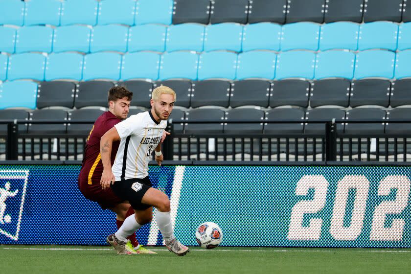 Simon Johansen #3 of the Cal State Golden Eagles is defended by Alex Townley #9 of the University of Charleston Golden Eagles