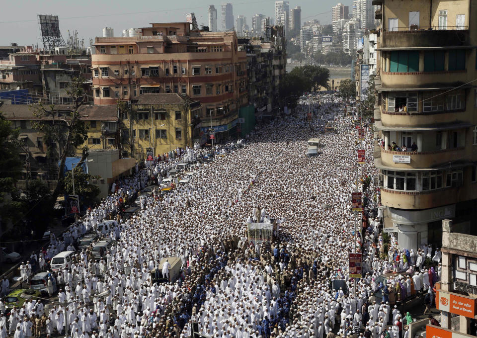 Indian Muslims join the funeral procession of the head of the Dawoodi Bohra Muslim community Syedna Mohammed Burhanuddin in Mumbai, India, Saturday, Jan. 18, 2014. A pre-dawn stampede killed more than a dozen people Saturday as tens of thousands of people gathered to mourn the death of Muslim spiritual leader Burhanuddin in the India's financial capital, police said. Burhanuddin died Friday at the age of 102. (AP Photo/Rajanish Kakade)
