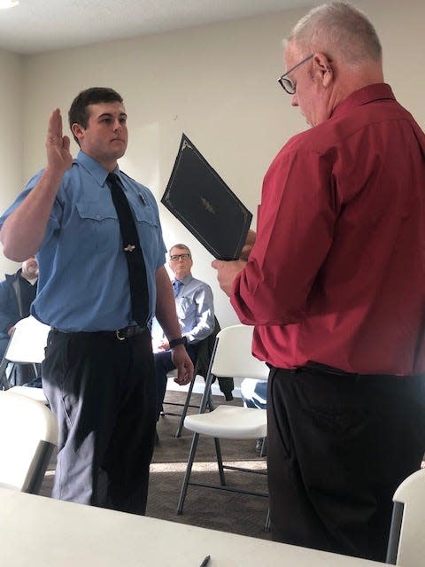 Bedford Mayor Sam Craig swears in Reid Marlow as a new member of the Bedford Fire Department during a meeting of the Bedford Board of Works & Safety Monday.