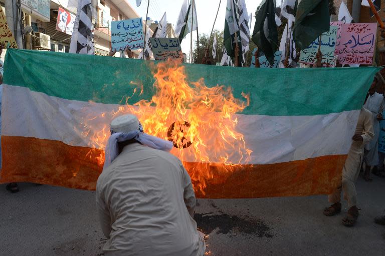 Pakistani activists torch an Indian flag during a demonstration in Quetta, on October 10, 2014