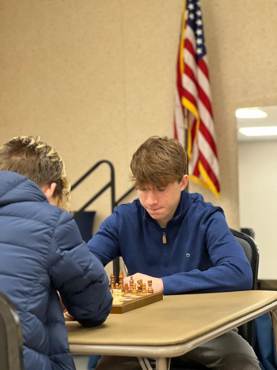 Ramsey Stiles, a junior at Highland School of Technology (far right), takes on Murphy Stiles in chess at a Gaston Chess meeting. The club meets 6:30 p.m. Tuesdays at Gaston County Senior Center in Dallas.