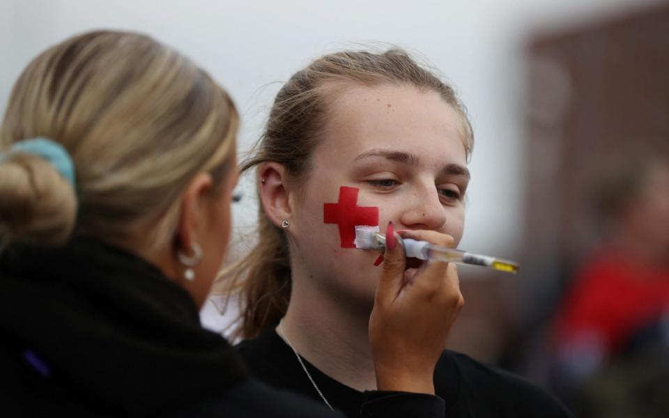 An England fan has her face painted before kick-off - Molly Darlington/Reuters