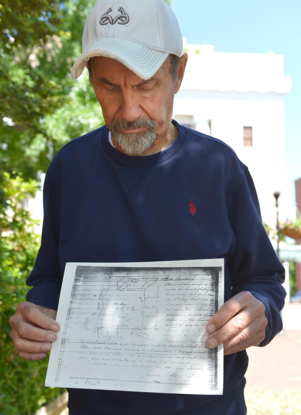 Carroll Caldwell holds up the original land grant for Nazareth Presbyterian Church, which dates back to the 1770s and Carroll's fourth great-grandfather.