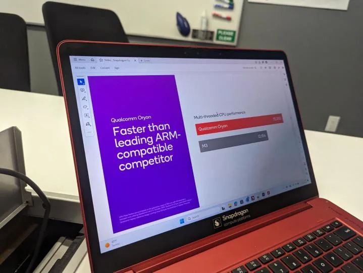 A Qualcomm demo laptop with a slide showing performance comparisons.