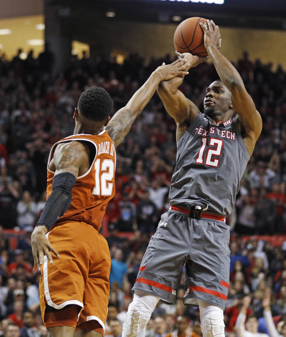 Texas Tech’s Keenan Evans (12) scores the game-winning basket over Texas’ Kerwin Roach (12) during overtime in an NCAA college basketball game Wednesday, Jan. 31, 2018, in Lubbock, Texas. (AP Photo/Brad Tollefson)