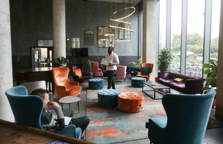 Residents and employees gather at the communal lounge area in the co-living building The Collective Old Oak in north west London