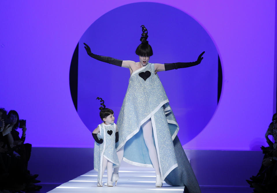 FILE - In this Wednesday, Jan. 24, 2018 file photo, Model Coco Rocha, right, poses with her 2-year-old daughter Ioni Conran wearing creations for the Jean Paul Gaultier Haute Couture Spring-Summer 2018 fashion collection presented in Paris. Fashion icon Jean Paul Gaultier has announced his retirement from couture catwalk collections - the designer’s only remaining runway shoe since putting an end to his ready-to-wear collections in 2014. In a tweet, the ever-smiling and flamboyant 67-year-old said the couture show on Wednesday, Jan. 22, 2020 “celebrating 50 years of my career will also be my last.” He added: “But rest assured, haute couture will continue with a new concept.” (AP Photo/Francois Mori, file)