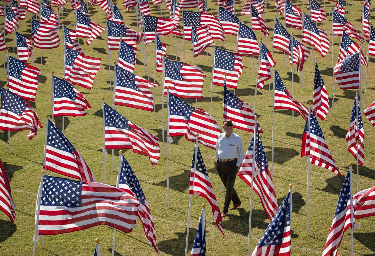Clark Thurmond, of Georgetown, walks through the Field of Honor in Georgetown after the Veterans Day ceremony on Thursday, November 11, 2021.
(Credit: Jay Janner/AMERICAN-STATESMAN/File)