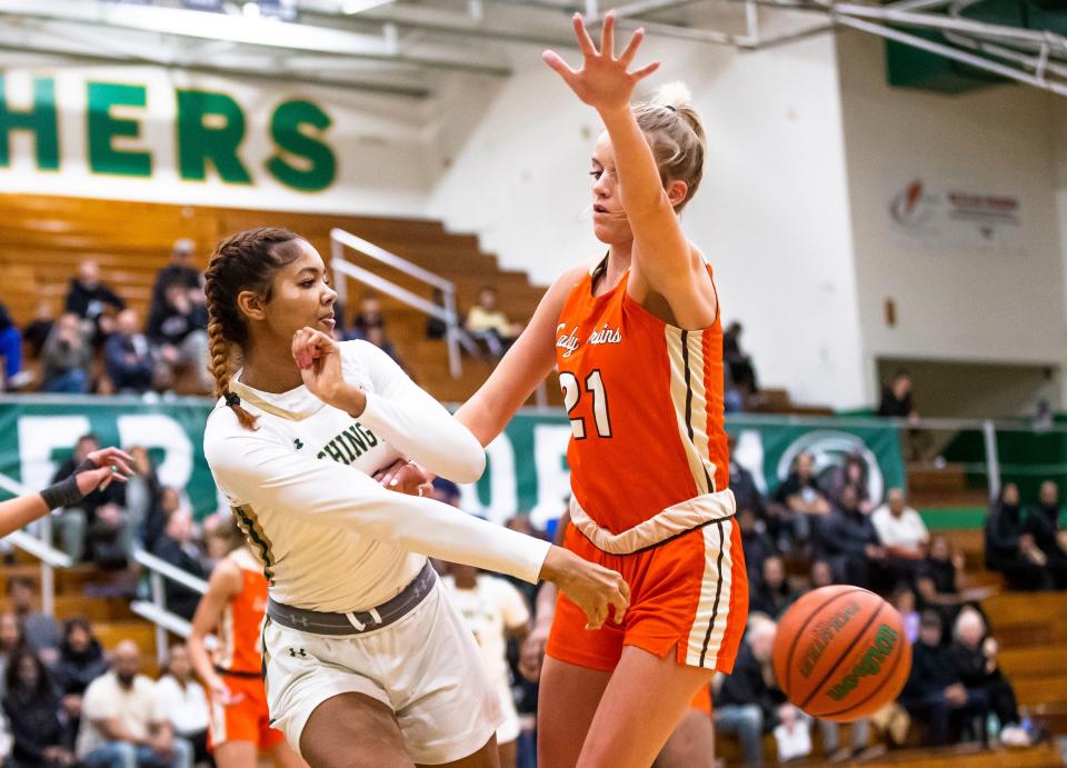 Washington's Kira Reynolds (11) gets a pass around Fort Wayne Northrop's Alexis Castator (21) during the Washington vs. Fort Wayne Northrop girls basketball game Wednesday, Jan. 18, 2023 at Washington High School.