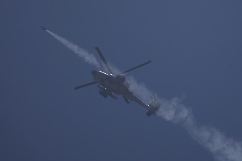 An Israeli Apache helicopter fires a missile towards the Gaza Strip, as seen from southern Israel, Thursday, May 16, 2024. (AP Photo/Leo Correa)