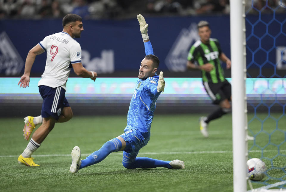 Vancouver Whitecaps' Lucas Cavallini (9) scores against Austin FC goalkeeper Brad Stuver during the second half of an MLS soccer match Saturday, Oct. 1, 2022, in Vancouver, British Columbia. (Darryl Dyck/The Canadian Press via AP)