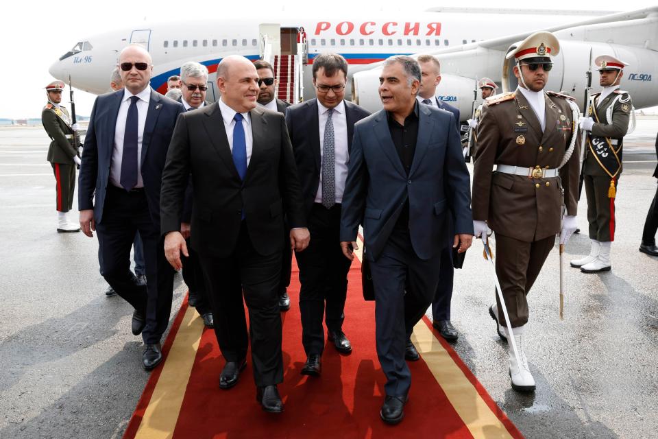 Russian Prime Minister Mikhail Mishustin, left, is welcomed by Iranian Oil Minister Mohsen Paknejad upon arrival at the Mehrabad International Airport in Tehran last month (AP)