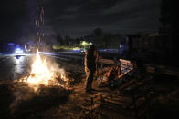 Farmers spend the night at a highway barricade in Aix-en-Provence, southern France, Tuesday, Jan. 30, 2024. France's protesting farmers encircled Paris with traffic-snarling barricades Monday, using hundreds of lumbering tractors and mounds of hay bales to block highways leading to France's capital to pressure the government over the future of their industry. (AP Photo/Daniel Cole)