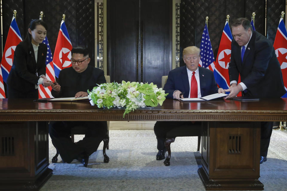 FILE - In this June 12, 2018, file photo, North Korea leader Kim Jong Un, center left, and U.S. President Donald Trump, center right, prepare to sign a document at the Capella resort on Sentosa Island in Singapore. At the last minute, Kim's sister, Kim Yo-jong, far left, provided a pen of her own for his use. Kim Jong Un's disappearance from the public eye is raising speculation about not only his health but also about who's next in line to run North Korea if anything happens to the leader. Some experts say his sister and close associate Kim Yo Jong is most likely since North Korea has been ruled by the Kim family for seven decades. (AP Photo/Evan Vucci, File)