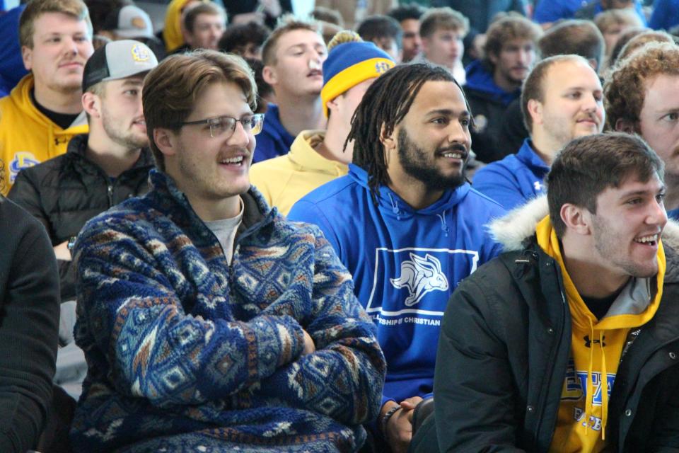 SDSU players (from left) Tucker Kraft, Quinton Hicks and Cale Reeder watch the FCS playoff selection show on Sunday at the Club 71 room at Dana J. Dykhouse Stadium.