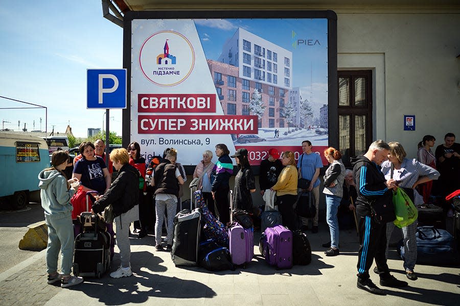 Refugees wait for humanitarian coaches at a transport hub May 11 in Lviv, Ukraine.