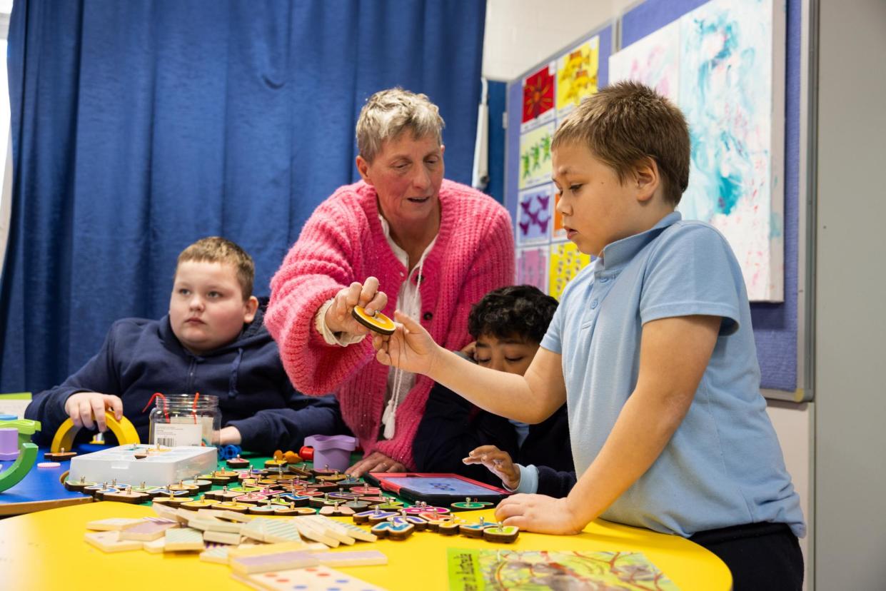 <span>Penelope Earp, deputy principal of Wairoa School, assists Saxon (left), Philip (centre) and Jakob with the explicit teaching method in Bondi, NSW.</span><span>Photograph: Blake Sharp-Wiggins/The Guardian</span>