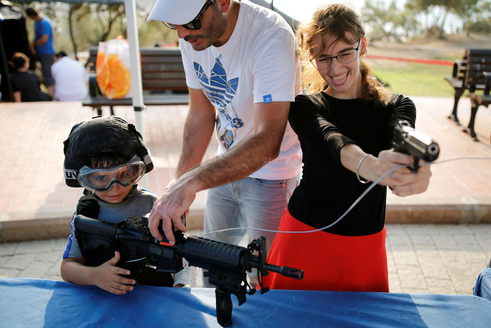 People play with firearms in Ashdod, Israel