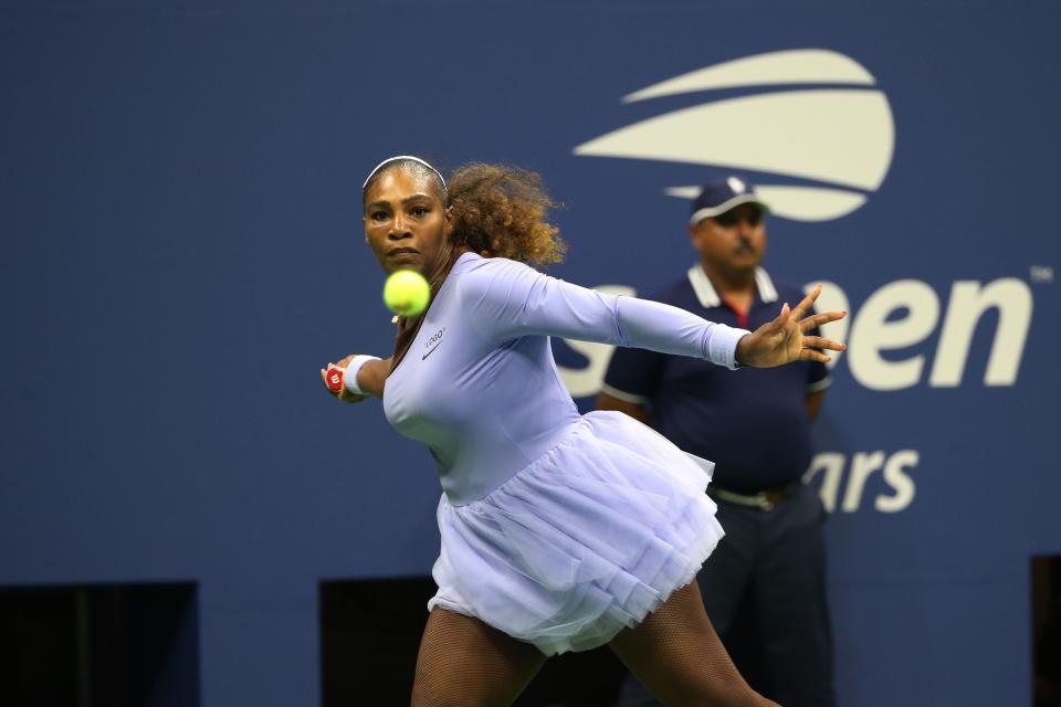 Serena Williams, rocking a lavender tutu, is about to smash a forehand in her second-round match. (Photo: Anadolu Agency via Getty Images)