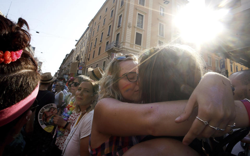 Revelers kiss during the gay pride parade in Milan, Italy, Saturday, June 29, 2019. (AP Photo/Luca Bruno)