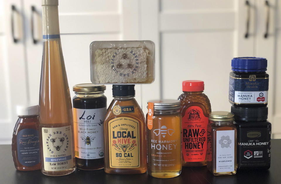 This February 24, 2020 photo taken in New York, shows some of the many brands and types of honey available today. Honey isn't just honey anymore. At farmers markets, grocery stores and restaurants, there's a wide assortment of honeys with various colors and tastes. (Katie Workman via AP)