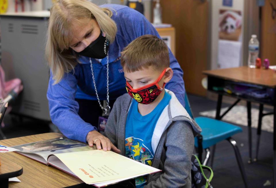Cheryl Montag, principal at J. F. Burns Elementary in Maineville, works with second grader, Cole Hitchcock, 7, November 5, 2021. Because of the urgent need for subs throughout Southwest Ohio and Northern Kentucky, Montag said administrators, like herself, are pressed into service to sub a few times a week. J. F. Burns is part of the Kings Local School District. During 2020-2021, the district spent $355,824 on substitute teachers. 