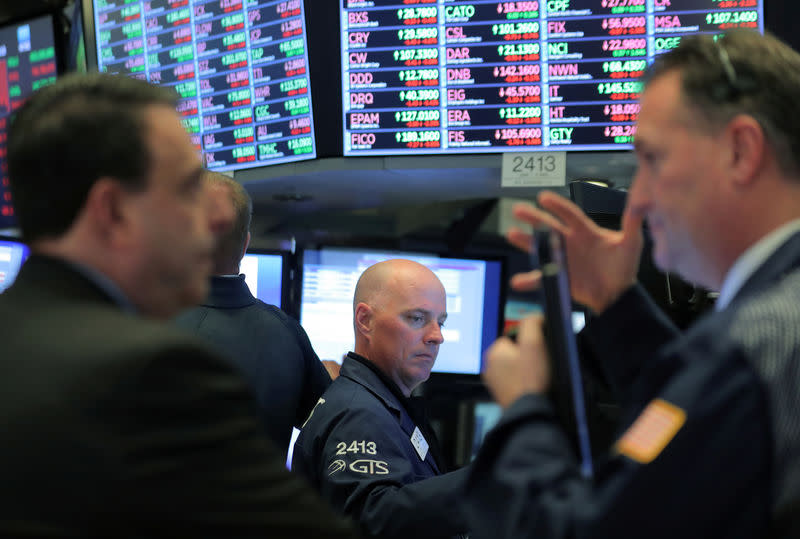 Traders work on the floor at the New York Stock Exchange (NYSE) in New York City, U.S., November 12, 2018. REUTERS/Brendan McDermid