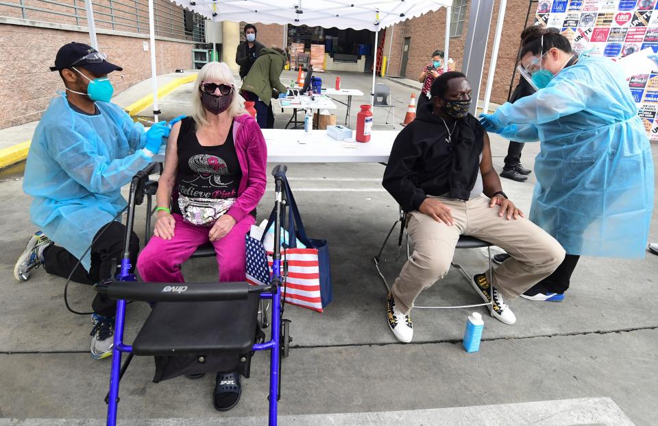 Registered nurses administer the Moderna COVID-19 vaccine to seniors experiencing homelessness at the Los Angeles Mission on Feb. 10, 2021. (Photo: FREDERIC J. BROWN/AFP via Getty Images)