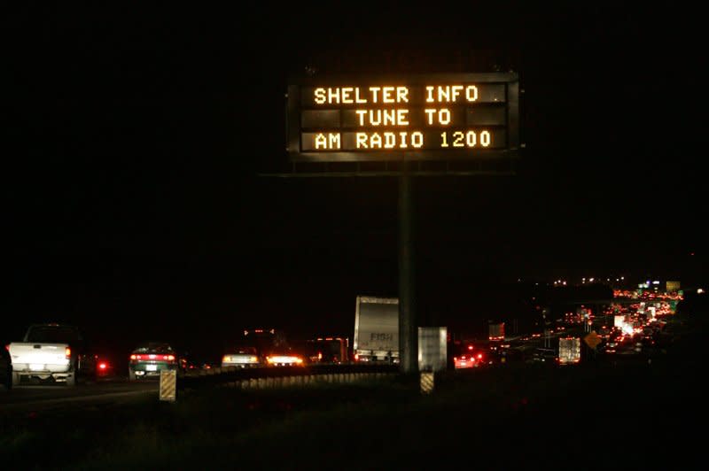 Hurricane Rita evacuees move away from the Texas Gulf on Interstate 10 outside of Houston early on September 23, 2005. Later that day, a fire killed 23 people on a bus carrying Texas nursing home evacuees inland. File Photo by Chris Carson/UPI