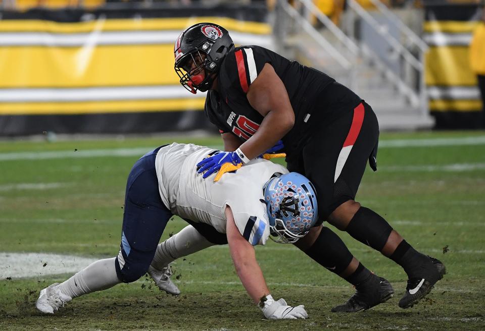 Naquan Crowder #70 of the Aliquippa Quips blocks against Tyler Ondrusek #51 of the Central Valley Warriors in the first half during the WPIAL Class 4A championship game game at Acrisure Stadium on November 25, 2022 in Pittsburgh, Pennsylvania.