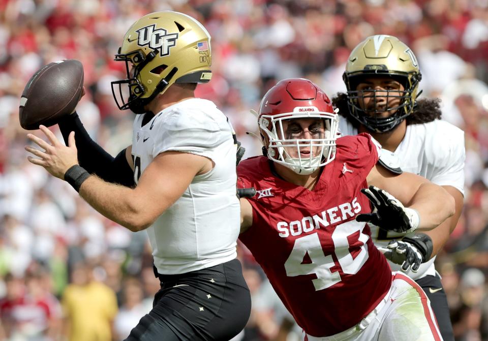 Oklahoma's Ethan Downs (40) pressures UCF's John Rhys Plumlee (10)in the first half of the college football game between the University of Oklahoma Sooners and the University of Central Florida Knights at Gaylord Family Oklahoma-Memorial Stadium in Norman, Okla., Saturday, Oct., 21, 2023.