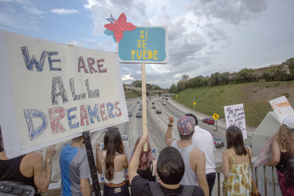 People hold signs over the 110 Freeway in Los Angeles as thousands of immigrants and supporters join the Defend DACA March to oppose President&nbsp;Donald Trump's decision&nbsp;to end DACA. (Photo: David McNew via Getty Images)