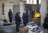 Women wearing face masks to protect against coronavirus shop at the Kalvarijos market in Vilnius, Lithuania, Tuesday, March 9, 2021. The quarantine restrictions have contributed to slowing the spread of the coronavirus (COVID-19) in Lithuania, but morbidity rates are still high. (AP Photo/Mindaugas Kulbis)