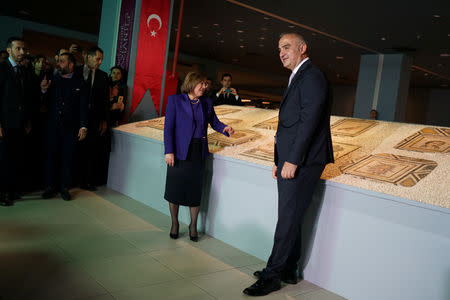 Culture and Tourism Minister Mehmet Ersoy and Gaziantep Mayor Fatma Sahin pose next to the missing pieces of the historic "Gypsy Girl" mosaic on display in an exhibition at their origin in Gaziantep, Turkey, December 8, 2018. REUTERS/Umit Bektas