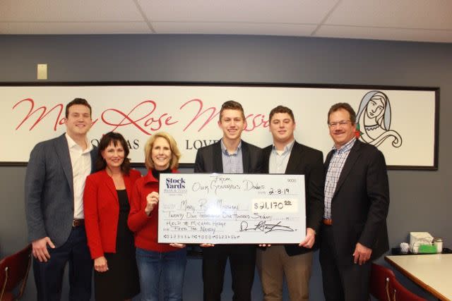 The Hodge family presented a check to Cindy Carris (third from left) and the Mary Rose Mission on Friday. The Hodges are pictured, from left to right, are: Andrew, Pamela, Michael, Alex and John.