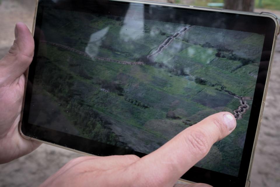 A Ukrainian aerial reconnaissance soldier shows new Russian positions dug in a village on the southern front line on May 23, 2023. (Francis Farrell/The Kyiv Independent)