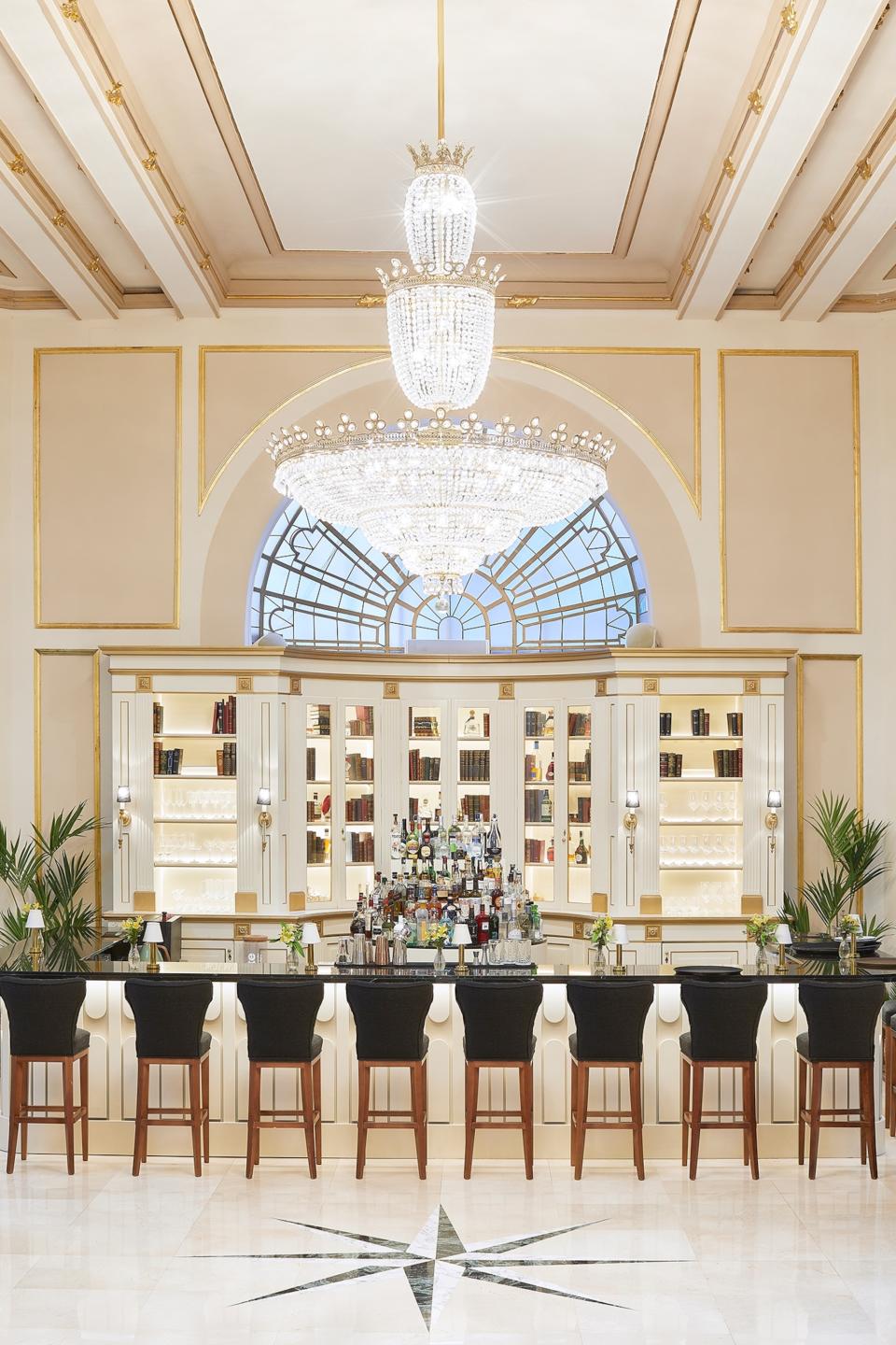 An interior view of an all white bar.