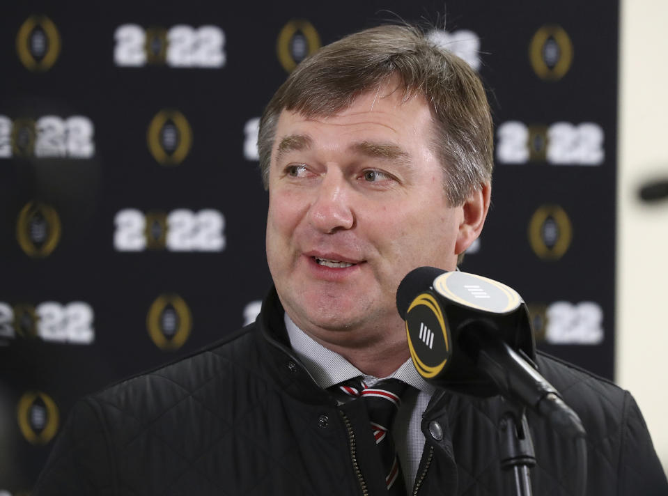 Georgia coach Kirby Smart smiles while taking a few questions after the team arrived at Indianapolis International Airport on Friday, Jan. 7, 2022, in Indianapolis. Georgia is scheduled to play Alabama in the College Football Playoff championship game Monday. (Curtis Compton/Atlanta Journal-Constitution via AP)