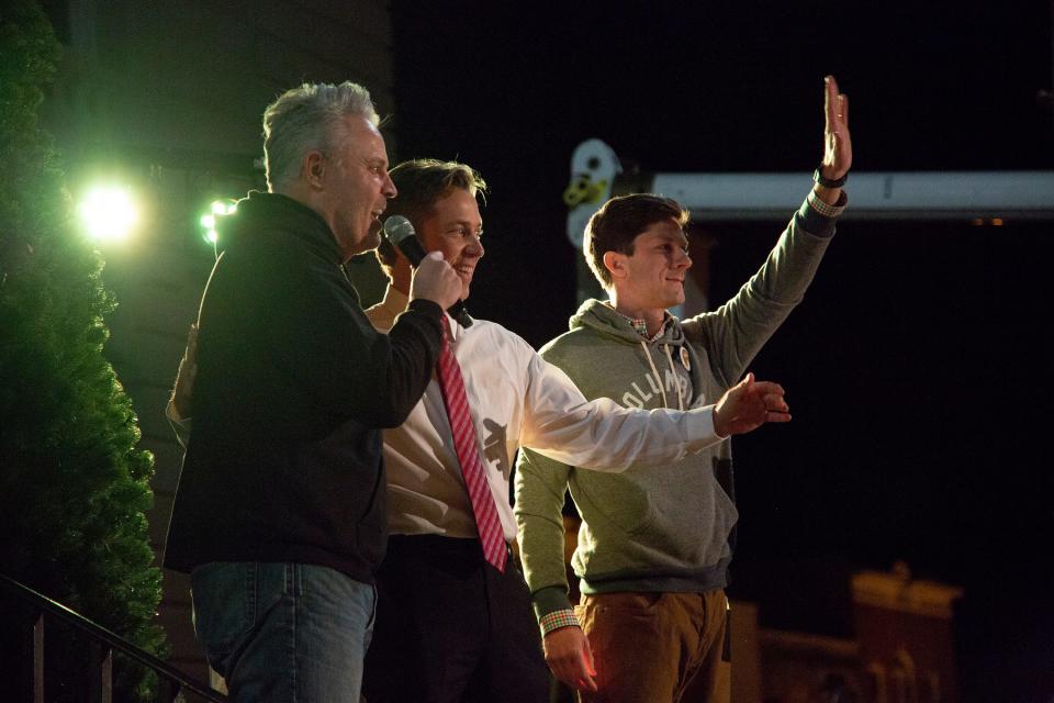 Maury County Mayor Andy Ogles, center, and incoming Columbia Mayor Chaz Molder, right. join emcee Blair Garner, left, on stage to lead a sing-a-long at the first Night of Light lighting ceremony of the new Christmas tree on the Columbia courthouse square on Sunday, Dec. 2, 2018.