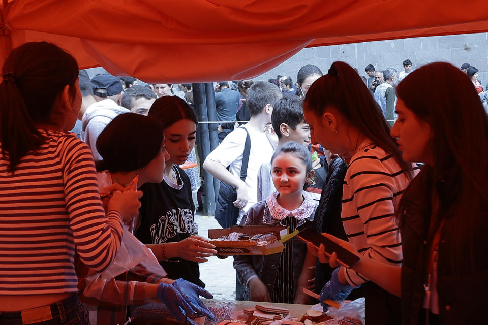 Ethnic Armenians from Nagorno-Karabakh receive humanitarian aid at a temporary camp in Armenia's Goris in Syunik region, Armenia, on Wednesday, Sept. 27, 2023. Some 42,500 people, or about 35% of Nagorno-Karabakh's ethnic Armenian population, had left for neighboring Armenia as of Wednesday morning, according to Armenian authorities. Hours-long traffic jams were reported on Tuesday on the road linking Nagorno-Karabakh to Armenia. (AP Photo/Vasily Krestyaninov)