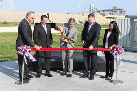 NASA's Kennedy Space Center Director Bob Cabana (center) helps cut the ribbon on the agency's Small Class Vehicle Launch Pad, called Pad-39C, in Florida during a facility opening ceremony on July 17, 2015. With him are (from left) Pat Simpkins,