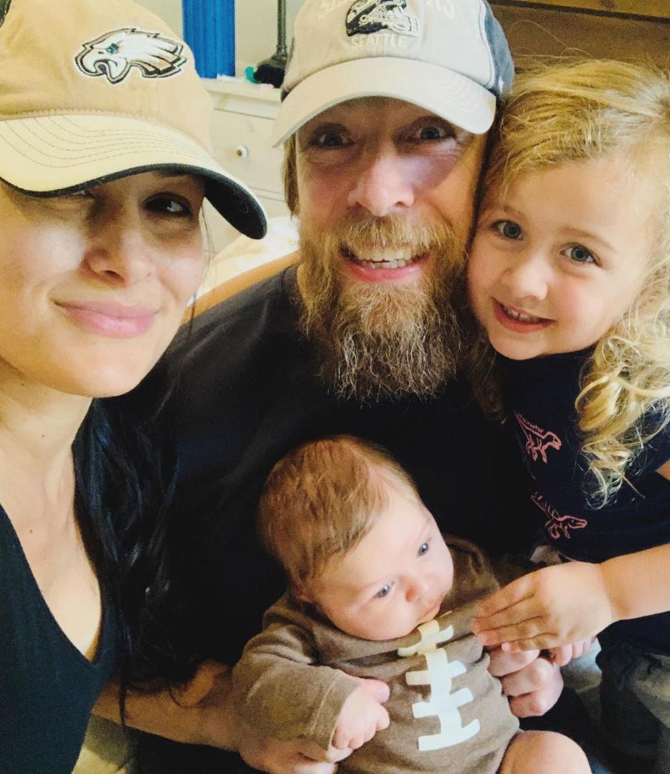 Bella ended the slideshow of photos with a sweet family snap of her husband, Daniel Bryan, with Buddy and Birdie. (@thebriebella / Instagram)