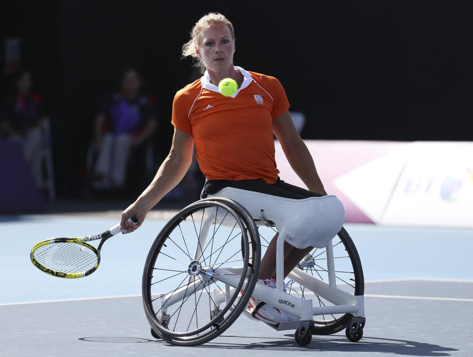 FILE - Netherlands' Esther Vergeer returns to Netherlands' Jiske Griffioen, not seen, during the women's single wheelchair tennis semifinal match at the 2012 Paralympics, Wednesday, Sept. 5, 2012, in London. Vergeer won the match. Wheelchair tennis star Esther Vergeer will be inducted into the International Tennis Hall of Fame on Saturday, July 22. (AP Photo/Raissa Ioussouf, File)