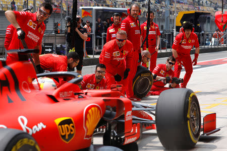 Formula One F1 - Chinese Grand Prix - Shanghai International Circuit, Shanghai, China - April 12, 2019 Ferrari's Sebastian Vettel and mechanics during practice REUTERS/Aly Song