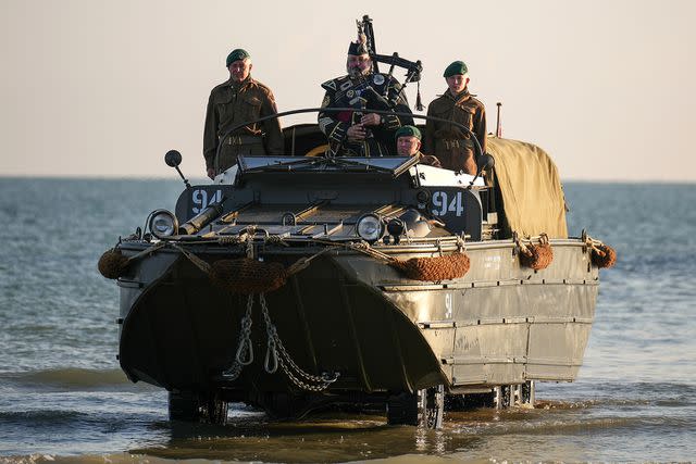 <p>Christopher Furlong/Getty</p> WWII landing craft arrives on Gold Beach in Normandy, France